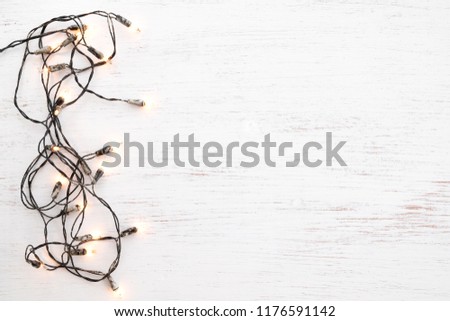 Christmas lights bulb decoration on white wood. Merry Christmas and New Year holiday background. top view