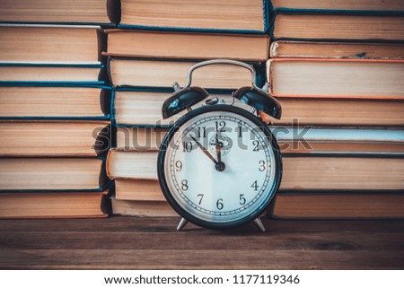 alarm clock on a books background