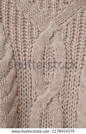Sweater or scarf texture large knitting. Knitted jersey background with a relief pattern