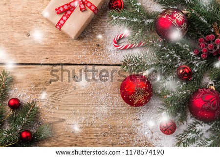 Christmas composition with fir tree branches and christmas decorations on wooden background, top view with copy space