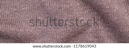 Metal Yarn Knitted  soft  Sleeve Top background, close up. Metallic knit cloth  texture of  Rose Silver Yarn, banner background
