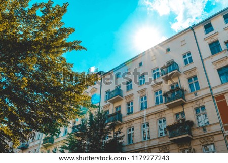 residential houses at prenzlauer berg, germany with lens flare on the top