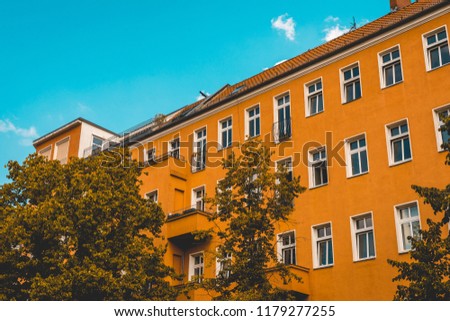 orange apartment building with darken sky in vintage colors