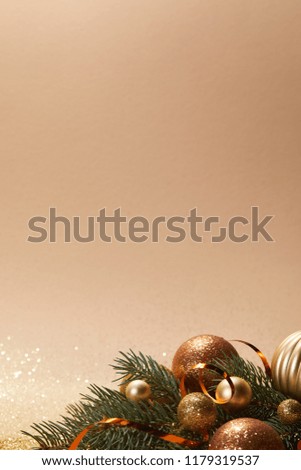 glittering christmas balls on pine branch isolated on beige