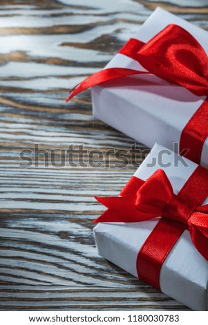 Set of red gift boxes on wooden background.