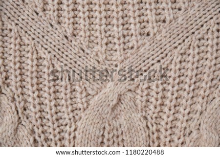 Sweater or scarf texture large knitting. Knitted jersey background with a relief pattern
