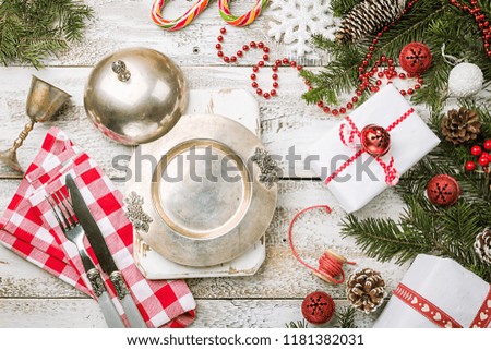 Christmas table place setting with festive decorations. Holidays background, top view with copy space