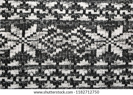 The texture of the knitted black and white fabric for the background  
