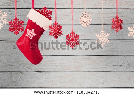 Christmas stocking hanging against wooden background