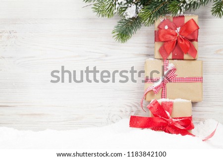 Christmas gift boxes and xmas fir tree branch. View with space for your greetings