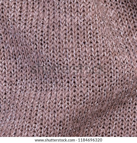 Metal Yarn Knitted background, close up. Metallic knit cloth  texture of  Beige Silver Yarn.