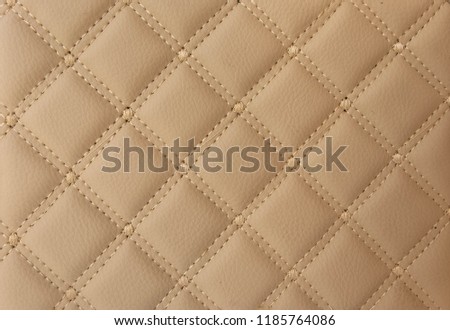 classic beige leather Mat with straight stitching soft leather machine foot textured pattern collection concept background business