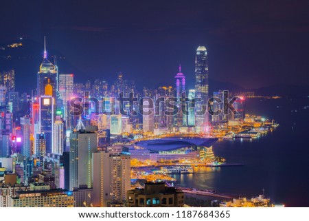 Hong Kong Downtown and Victoria Harbour. Financial district in smart city. Skyscraper and high-rise buildings. Aerial view at night.