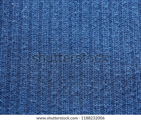 warm blue dark woolen sweater fabric texture background wool close-up. season winter autumn spring