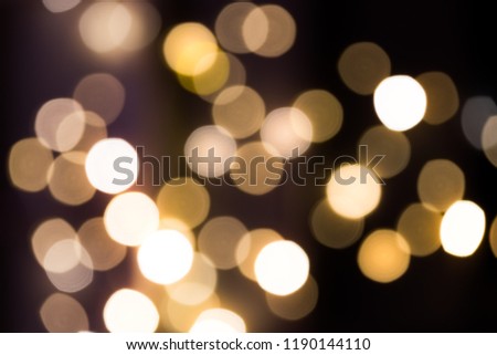 Circles of bright lights in in the dark.Bokeh Gold background image.Abstract bokeh