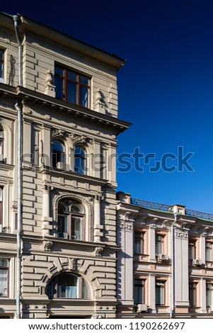 the facade of the building in the classical style against the blue sky