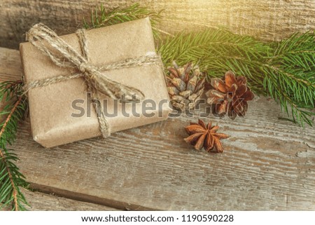 Christmas New Year composition with gift box fir branch pine cones anise on old shabby rustic wooden background. Xmas holiday december decoration to Russian tradition. Flat lay, copy space