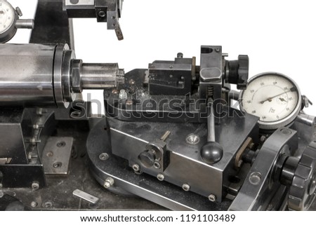 Manually operated lathe for making contact lenses.