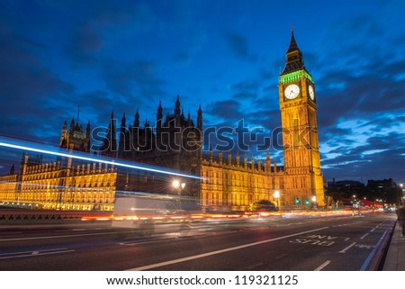 Nocturne scene with Big Ben and House of Parliament behind light beams - London - UK