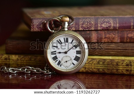 Old books and pocket watch