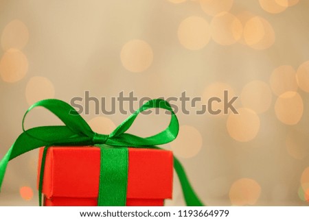 One red christmas gift box with green ribbon and copy space