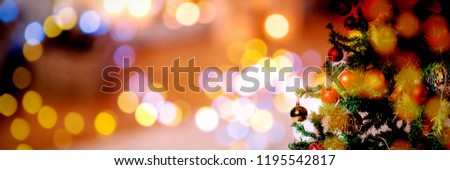 Christmas yellow circle lights against christmas pine tree with gifts