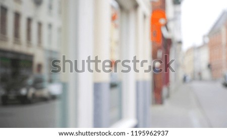 Blurry backdrop of storefront and sidewalk in European town for compositing