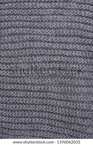 Knitted gray sweater pattern. Fabric texture. Top view.

