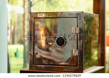 Shiny safe that reflects the fire, with a combination lock