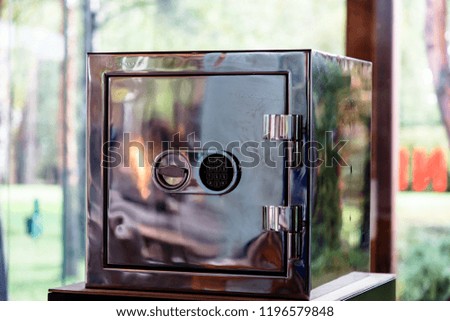 Shiny safe that reflects the fire, with a combination lock
