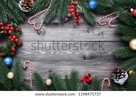Christmas decorations with candy canes on wooden table