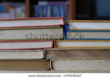 Close-up of old books stacked on library table selective focus and shallow depth of field