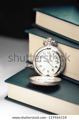 Pocket watch on a pile of books