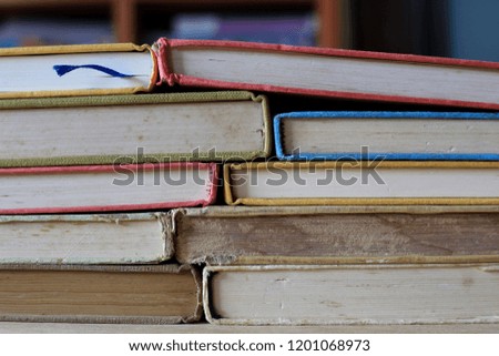 Close-up of old books stacked on library table selective focus and shallow depth of field