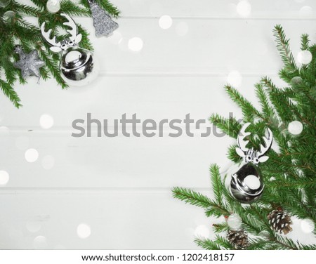 christmas background and decoration with fir branches garland lights on white wooden board