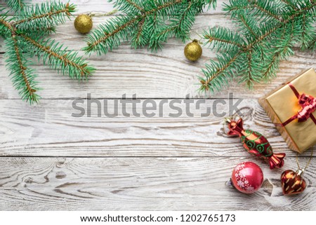 Holiday frame of Christmas decorations on white background with fir branch, gold and red balls, stars, box gift. Elegant New Year`s snowy card. Top view. Flat lay.