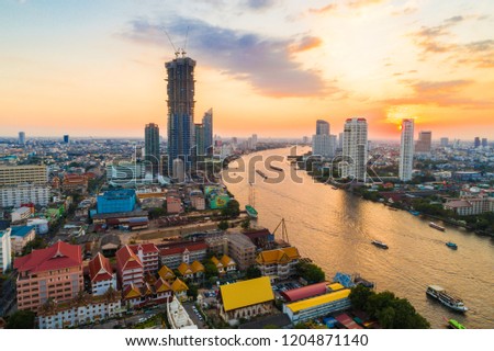 Sunset over the city building with transport road aerial view, Bangkok Thailand
