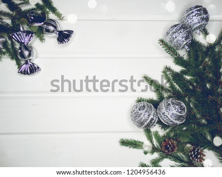 christmas background and decoration with fir branches garland lights on white wooden board