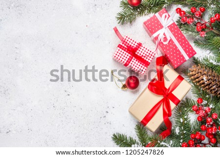 Christmas background with fir tree, present box and decorations on white background. Top view copy space.