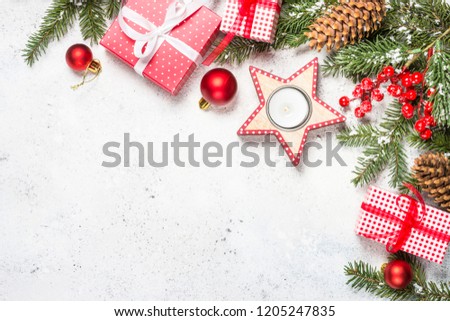 Christmas background with fir tree, candle and decorations on white background . Top view copy space.