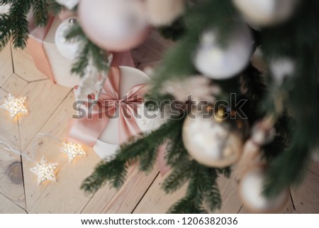 pink gifts with bow under a Christmas tree