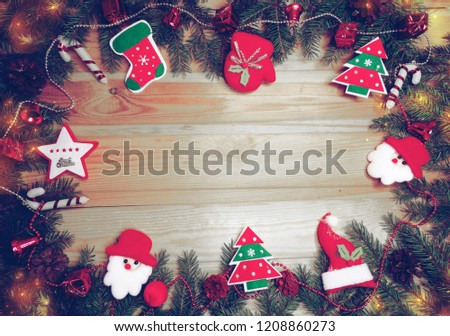 christmas background and decoration with fir branches garland lights on old wooden board copy space