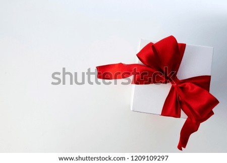 Red Bow Gift Box With space for white-light design, with concept of holiday, New Year, Christmas