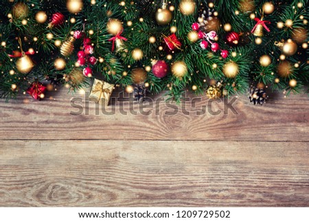 Christmas fir tree branches with toys on old wooden table
