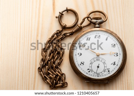 Old pocket watch on a shingle