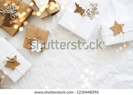Christmas handmade gift boxes on white crumpled background top view. Merry Christmas greeting card, frame. Winter xmas holiday theme. Happy New Year. Flat lay