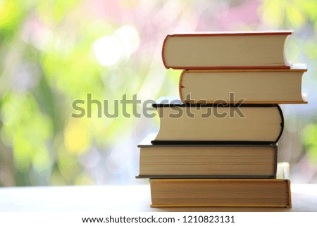 Close-up of colorful books stacked on a table natural colors are the background selective focus and shallow depth of field