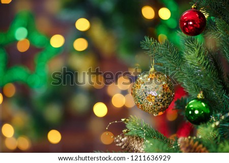 Christmas tree branch and lights on wooden background.