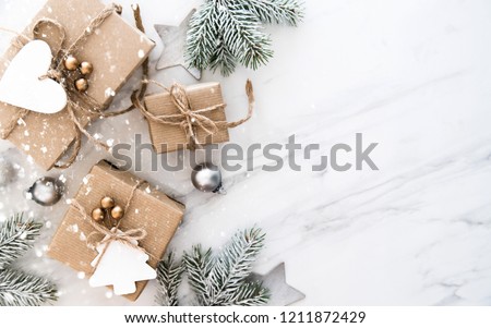 Christmas handmade gift boxes on white marble background top view. Merry Christmas greeting card, frame. Winter xmas holiday theme. Happy New Year. Flat lay