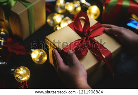 Hand Holding Christmas Present 